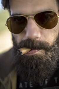 Close-Up Photo of Man Smoking Cigar